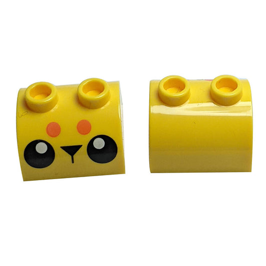 Yellow Slope, Curved 2 x 2 x 1 Double with Two Studs with Black Eyes, Triangle Nose and 2 Orange Dots Pattern